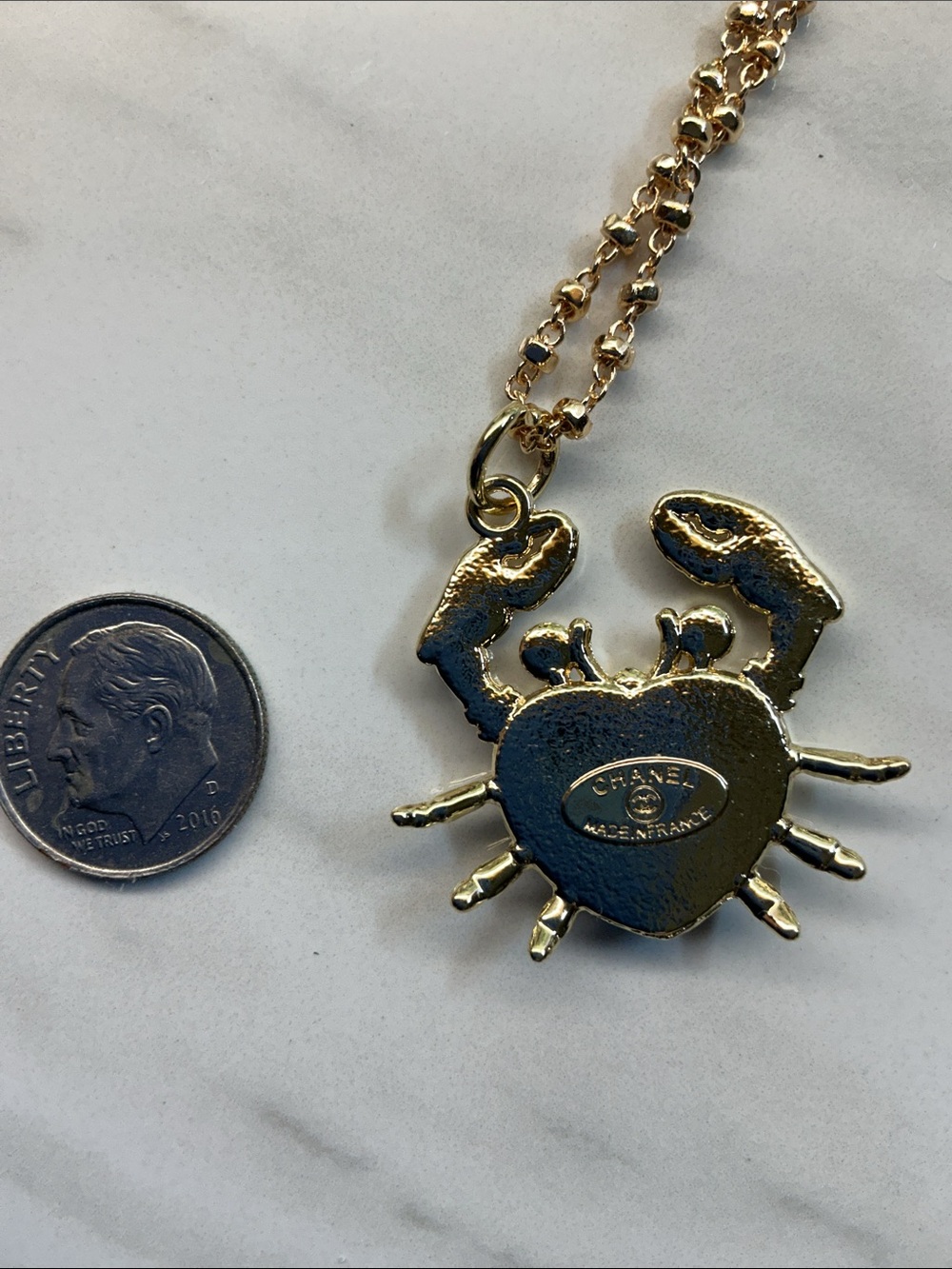 Gold-Tone Crab Pendant Necklace with White Enamel Heart and Black Logo - Picture 4 of 7